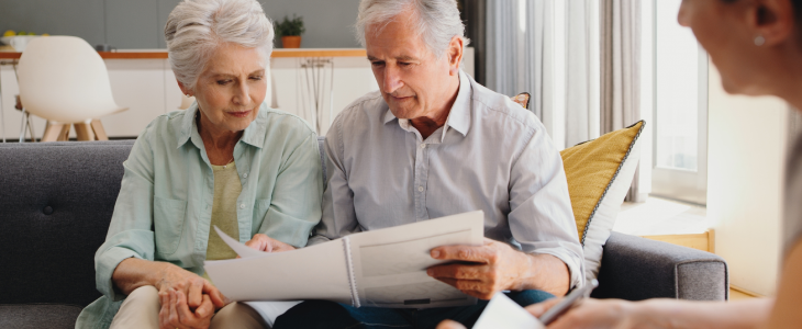 Elder couple speaking with estate planning lawyer